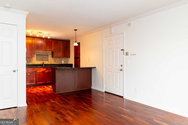 kitchen with ornamental molding, decorative light fixtures, backsplash, and sink