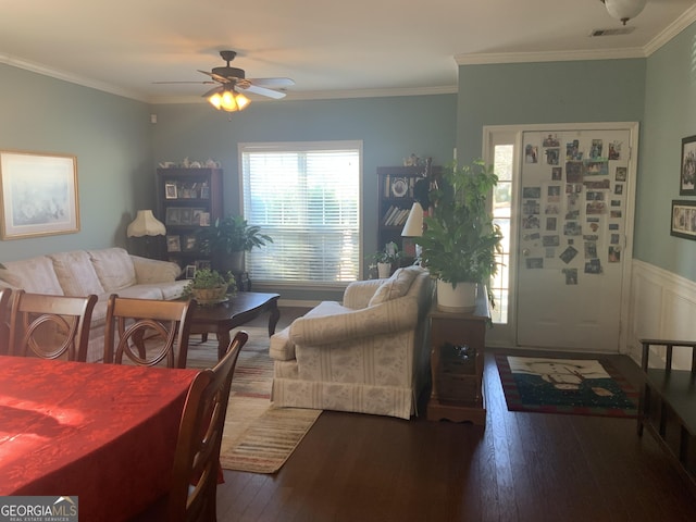 living room featuring ornamental molding, ceiling fan, and dark wood-type flooring