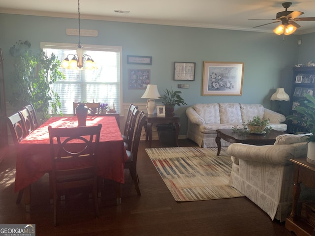 dining area featuring ceiling fan with notable chandelier and crown molding