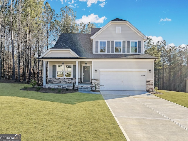 view of front of home featuring a front yard, a porch, and a garage