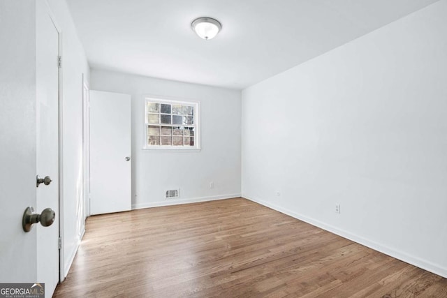 spare room with light hardwood / wood-style floors