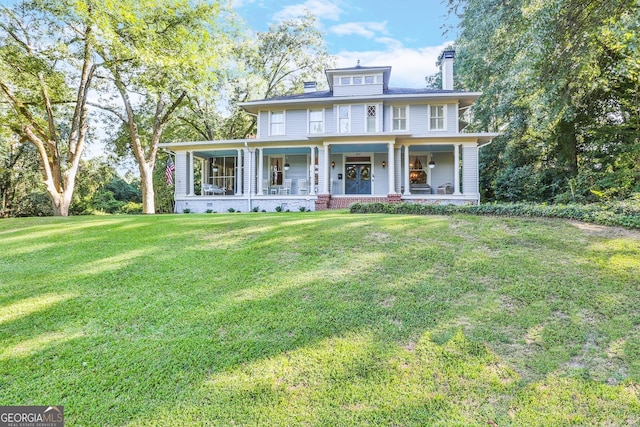 view of front of property with covered porch and a front yard