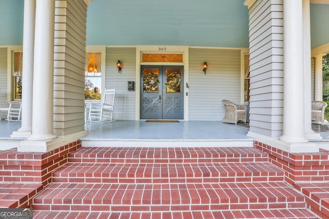 doorway to property featuring covered porch