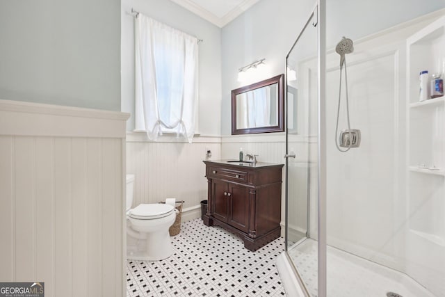 bathroom with an enclosed shower, vanity, crown molding, toilet, and wood walls