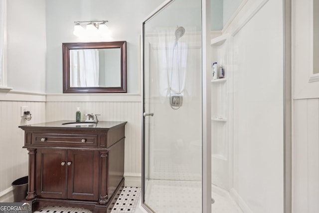 bathroom with tile patterned flooring, vanity, and a shower with shower door