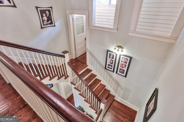 staircase featuring wood-type flooring