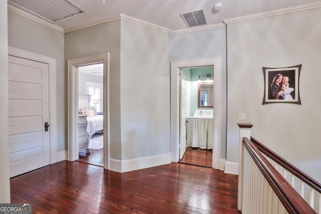 hallway with dark hardwood / wood-style floors and ornamental molding