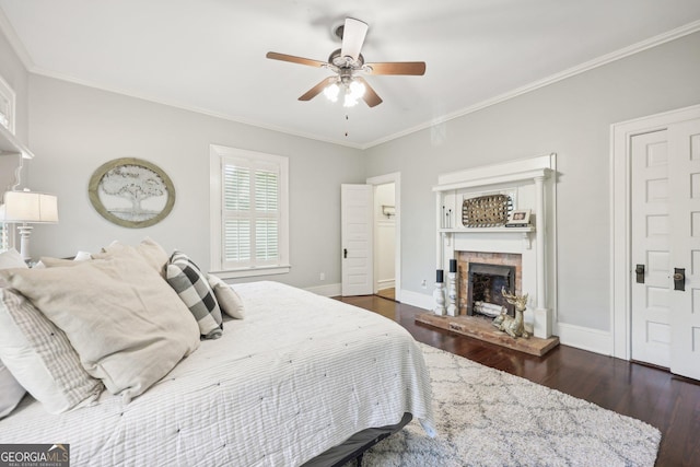 bedroom featuring ceiling fan, dark hardwood / wood-style floors, and ornamental molding