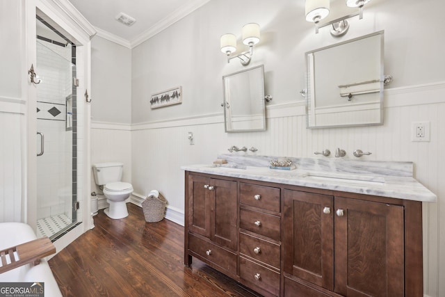 bathroom with wood-type flooring, an enclosed shower, toilet, vanity, and ornamental molding