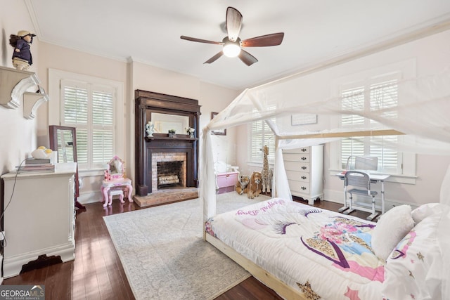 bedroom featuring dark hardwood / wood-style floors, ceiling fan, and ornamental molding