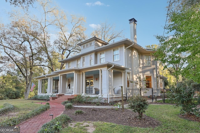 view of front facade with covered porch and a front lawn