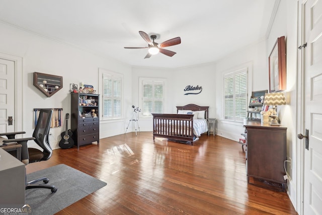 bedroom with hardwood / wood-style floors, ceiling fan, and ornamental molding