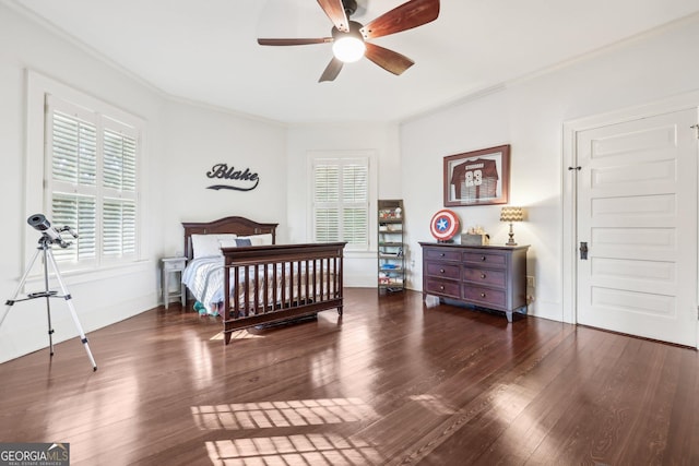 bedroom featuring crown molding, ceiling fan, and dark wood-type flooring