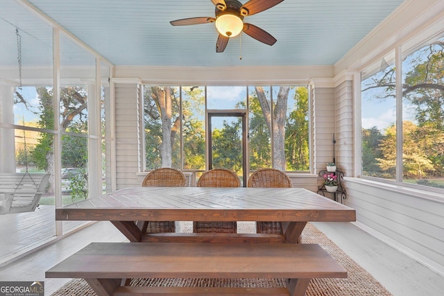 unfurnished sunroom featuring ceiling fan