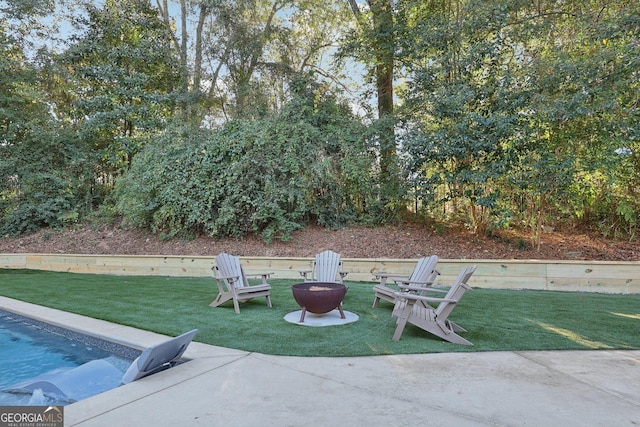 view of patio / terrace featuring a swimming pool and an outdoor fire pit