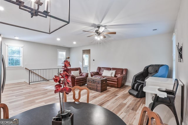 living room featuring ceiling fan and light hardwood / wood-style floors