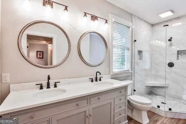 bathroom with toilet, a shower with door, vanity, and hardwood / wood-style flooring