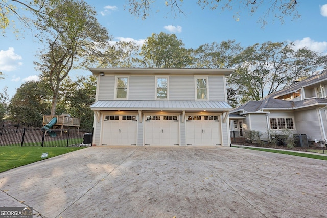 view of front of house featuring a front yard, a garage, and cooling unit