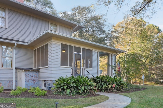 view of side of property featuring a sunroom