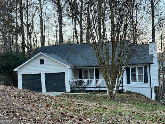 single story home with a garage and covered porch