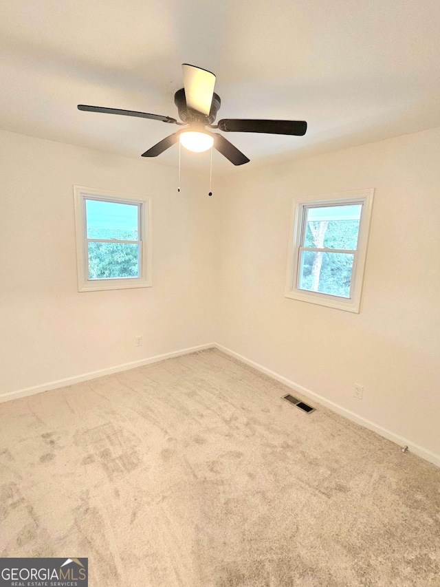 carpeted empty room with ceiling fan