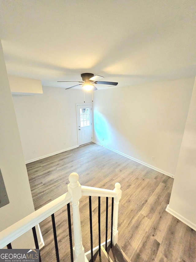 empty room featuring ceiling fan and hardwood / wood-style flooring