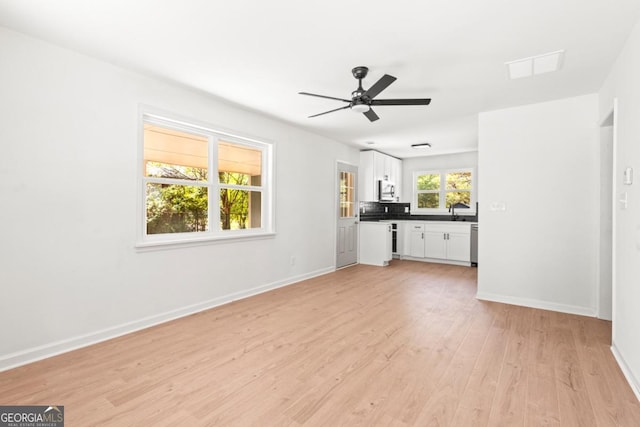 unfurnished living room with ceiling fan and light hardwood / wood-style flooring