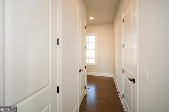 corridor featuring dark hardwood / wood-style flooring