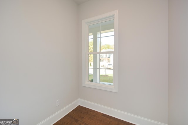 unfurnished room featuring hardwood / wood-style floors and plenty of natural light