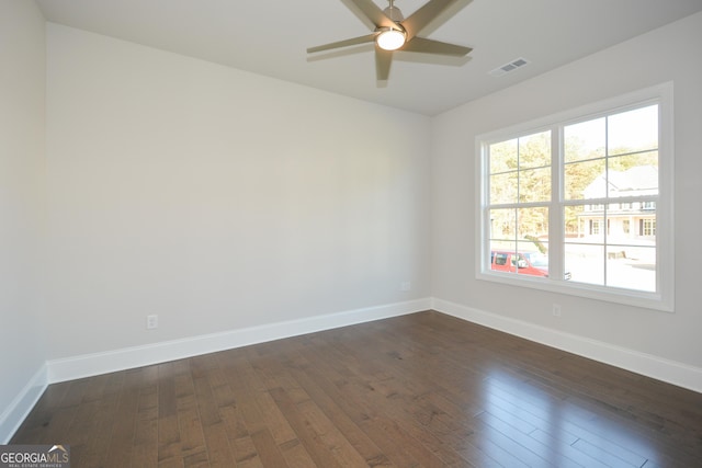 spare room with ceiling fan and dark wood-type flooring