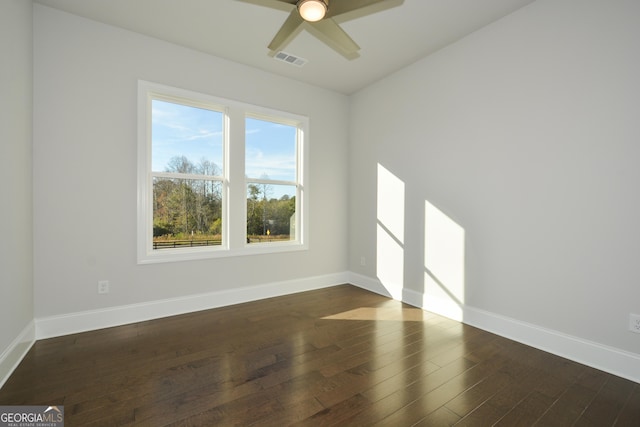 spare room with ceiling fan and dark wood-type flooring