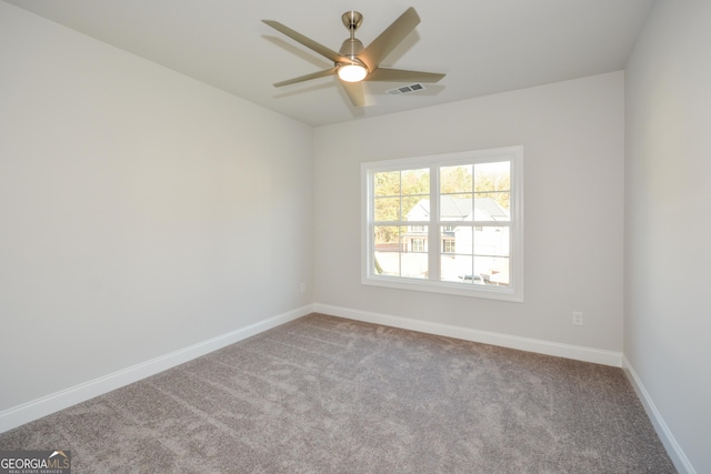 carpeted spare room featuring ceiling fan