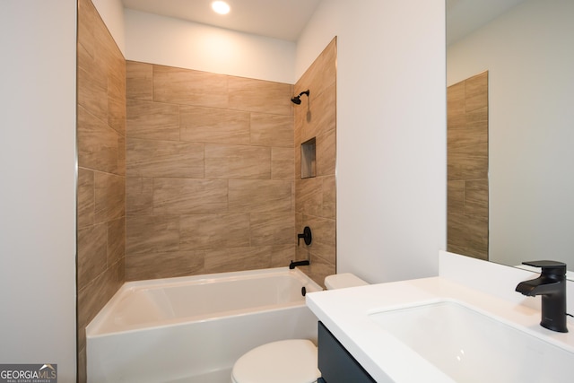 full bathroom with vanity, tiled shower / bath, and toilet