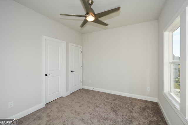 spare room featuring carpet flooring and ceiling fan