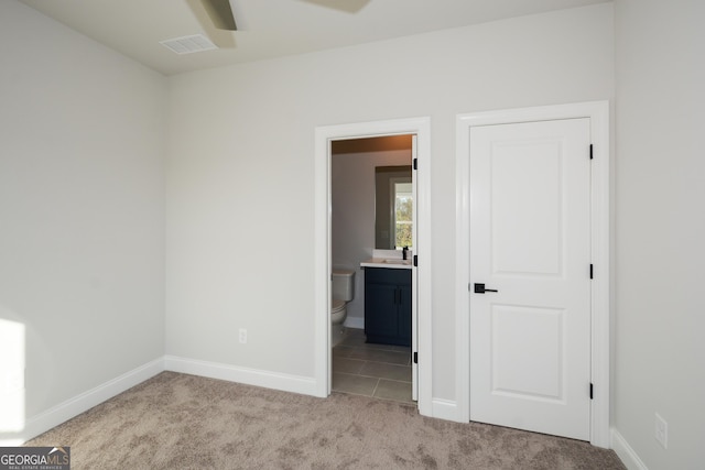 unfurnished room with light carpet and sink