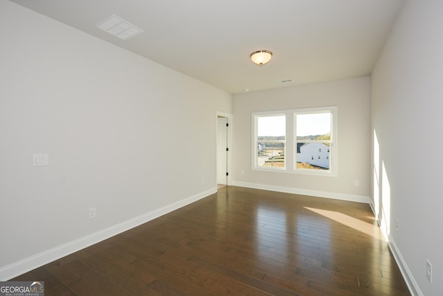 unfurnished room featuring dark hardwood / wood-style floors