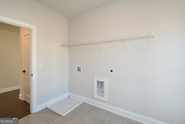 washroom with electric dryer hookup, light tile patterned flooring, and hookup for a washing machine