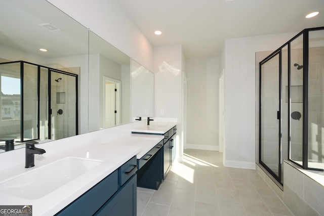 bathroom featuring tile patterned floors, a shower with door, and vanity