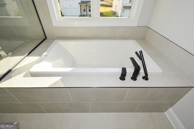 bathroom featuring a relaxing tiled tub