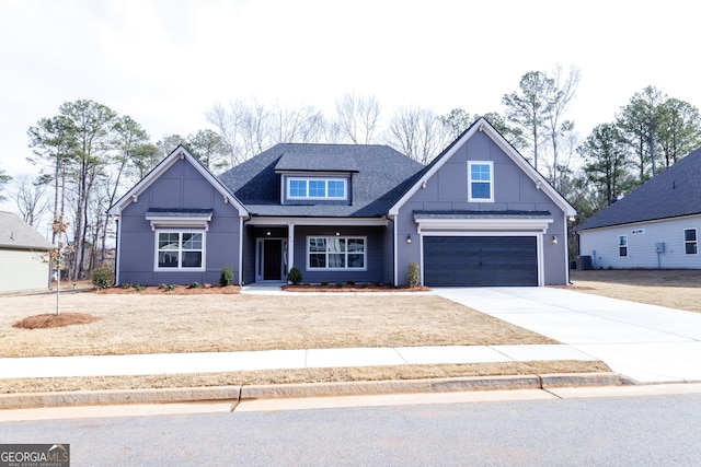 craftsman inspired home featuring a garage and central air condition unit