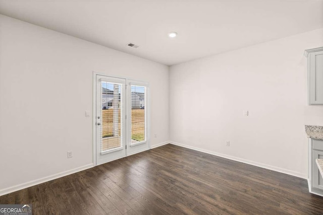 spare room with dark hardwood / wood-style floors