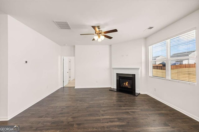 unfurnished living room featuring dark hardwood / wood-style floors and ceiling fan