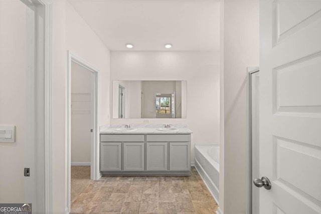 bathroom with a bath and vanity