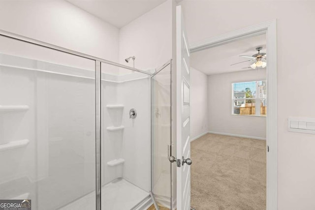 bathroom with ceiling fan and a shower with shower door