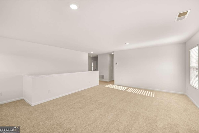 empty room with light colored carpet