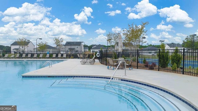 view of swimming pool featuring a patio area