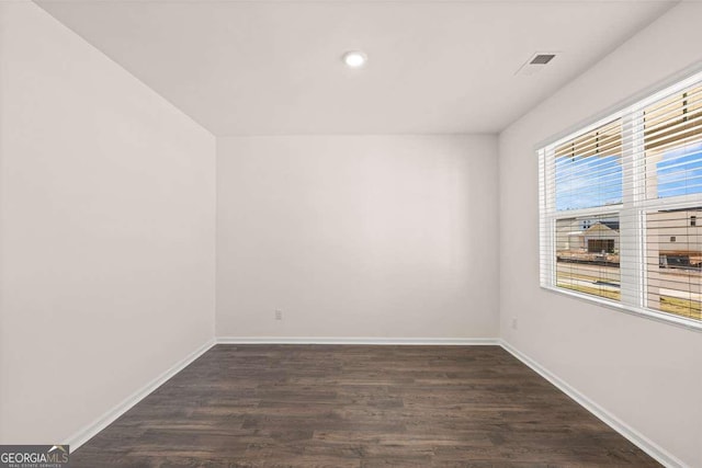 spare room featuring dark hardwood / wood-style flooring