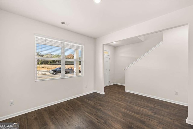 empty room with dark wood-type flooring