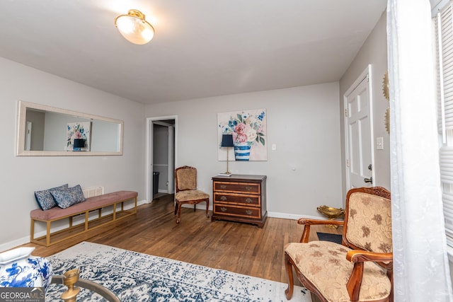 sitting room with hardwood / wood-style flooring