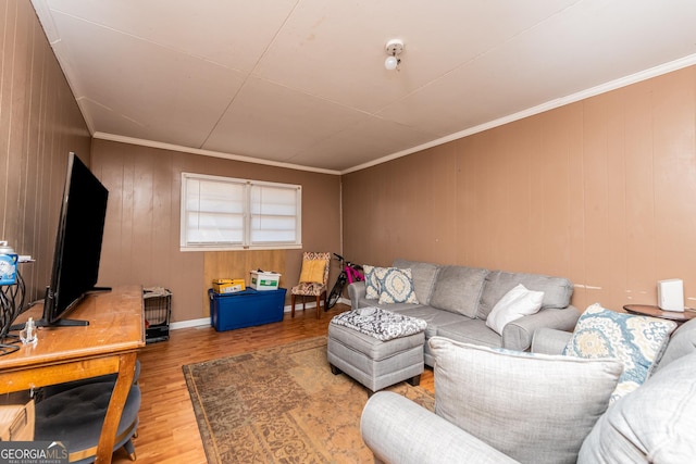 living room with hardwood / wood-style floors, ornamental molding, and wooden walls